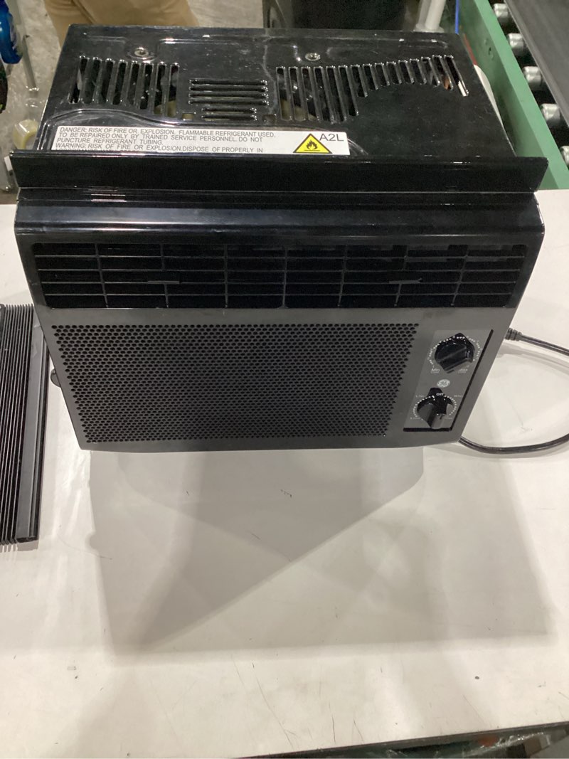 Condition photo showing As Is for **untested** ge window air conditioner unit, 5,000 btu for small rooms up to 150 sq ft. with manual adjustable fan and cooling settings, perfect for bedroom or living room, easy install kit included, black 5,000 btu mechanical controls black