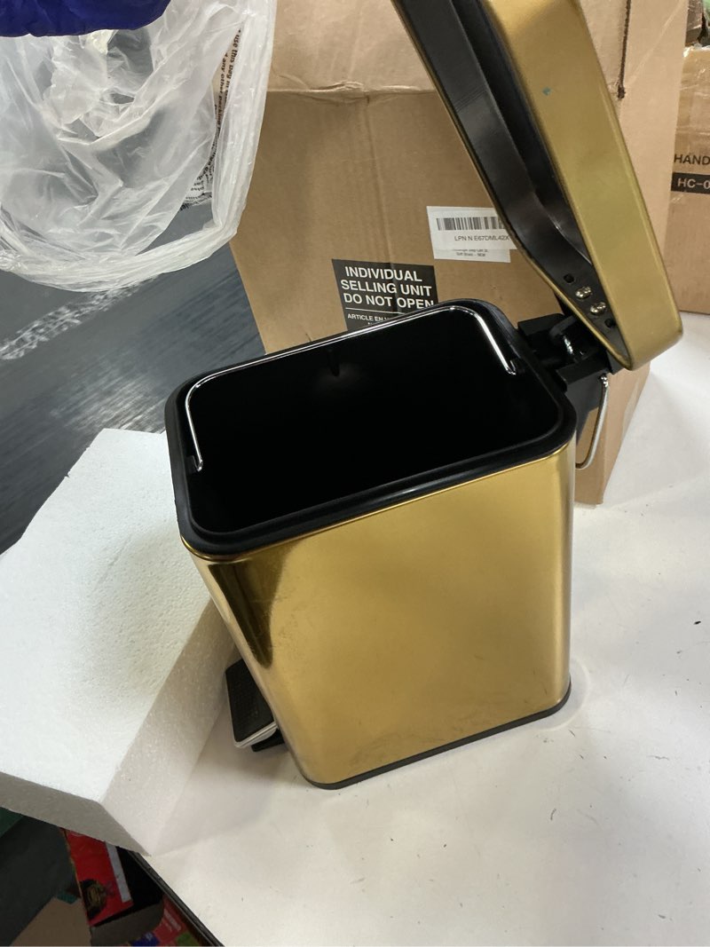 Condition photo showing Good Condition for mdesign slim metal rectangle 0.8 gallon trash can with step pedal, easy-close lid, removable liner - narrow wastebasket garbage container bin for bathroom, bedroom, kitchen, office - soft brass soft brass .8 gallon