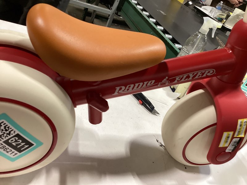 Condition photo showing As Is for radio flyer steady start balance bike, red, for kids ages 1-3, pedal free for quick learning, wide front and dual rear tires, tool-free adjustable seat, quiet ride wheels, kid & toddler balance bikes