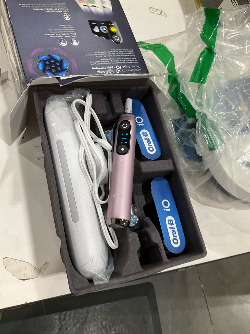Condition photo showing As Is for oral-b rechargeable electric toothbrush, io9 genius, 7 cleaning modes, interactive display, charging travel case, visible pressure sensor, 4 brush heads, rose quartz rosequartz 1 count (pack of 1) io9 power handle