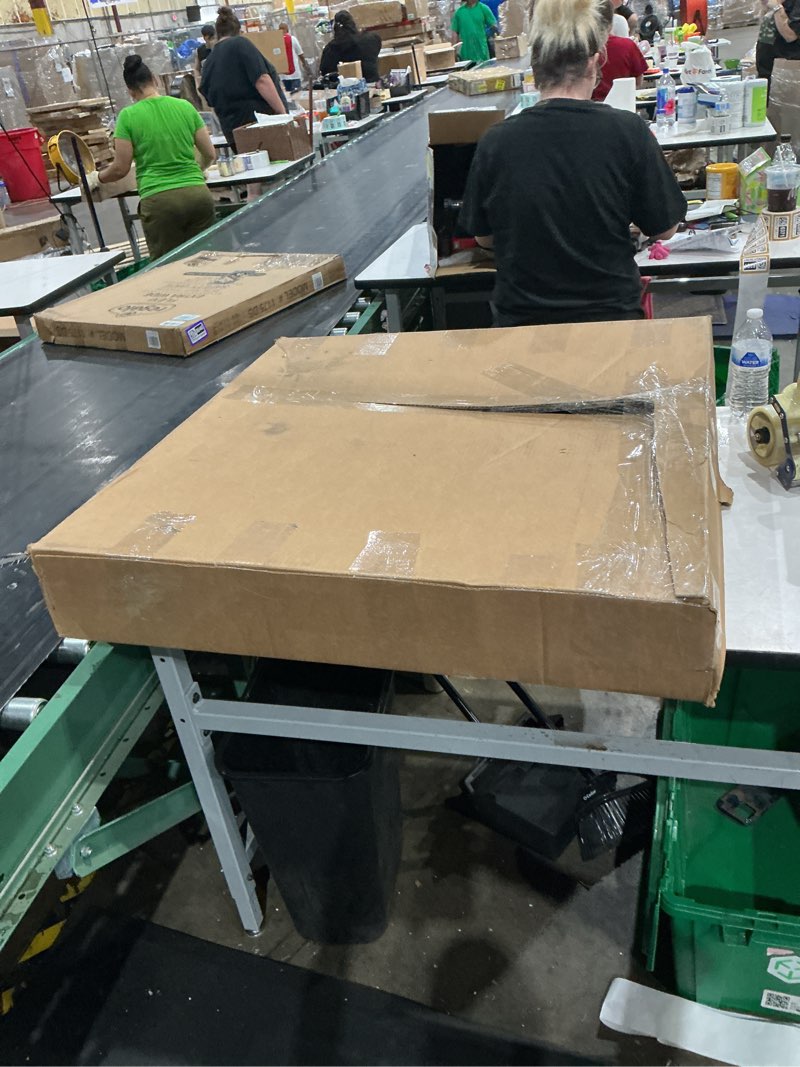 Condition photo showing As Is for stainless steel table on wheels