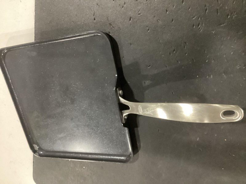 Condition photo showing As Is for oxo enhanced 11" griddle pan, pfas-free ceramic nonstick, durable hard anodized cookware, scratch resistant, stainless steel handle, good grips, dishwasher safe, oven safe, black