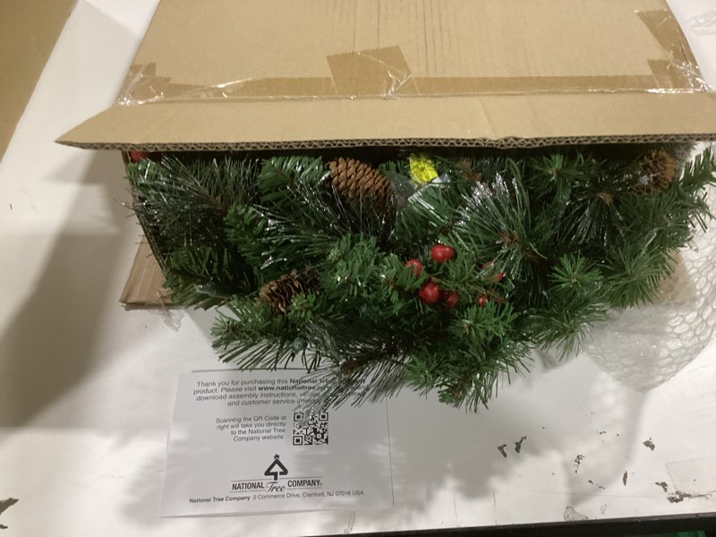 Condition photo showing Good Condition for National Tree Company 24 in Pre-Lit Crestwood Spruce Artificial Christmas Wreath, Christmas Decoration with Glitter, Pinecones, Red Berries, 50 Clear Lights, 160 Tips, Green 24 in Plug In Wreath