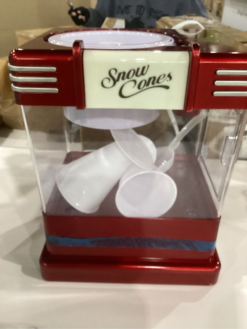Condition photo showing As Is for nostalgia snow cone maker tabletop shaved ice machine with 2 reusable cones & ice scoop  red