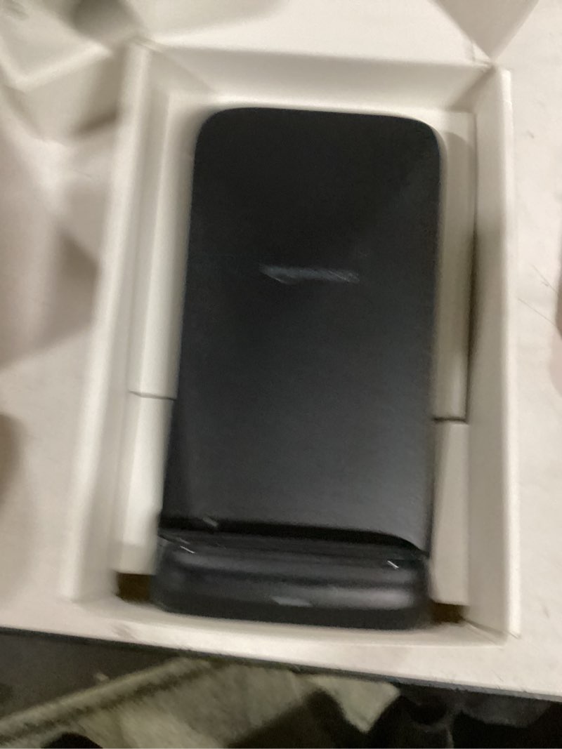 Condition photo showing As Is for Amazon Basics 10W Qi Certified Wireless Charging Stand for Phone 16/15/14/13/12/11/X, Samsung, and More, with USB Cable, Black (No AC Adapter)