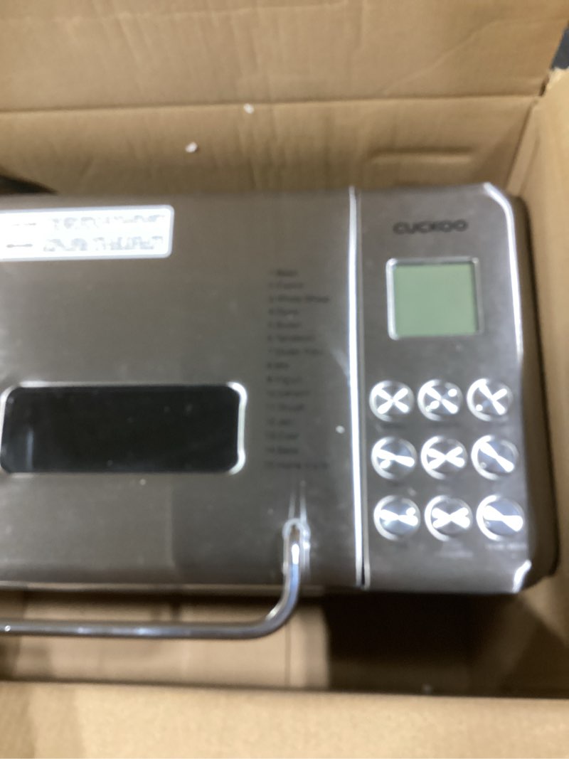 Condition photo showing As Is for CUCKOO Bread Maker Machine with 15 Menu Options + 3 Crust Colors, 2 lbs Bread Machine with Automatic Fruit & Nut Dispenser, Includes 6 Accessories, Ideal Breadmaker for Sourdough (CBM-AAB101S)