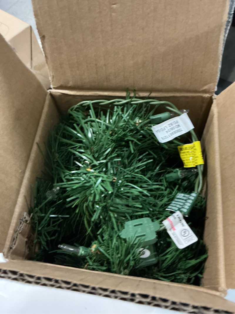 Condition photo showing Good Condition for National Tree Company 24 in Pre-Lit Majestic Fir Mini Artificial Christmas Tree, 35 Clear Lights, 71 Tips, Red Cloth Base, Green Plug in w/Red Bag Tree