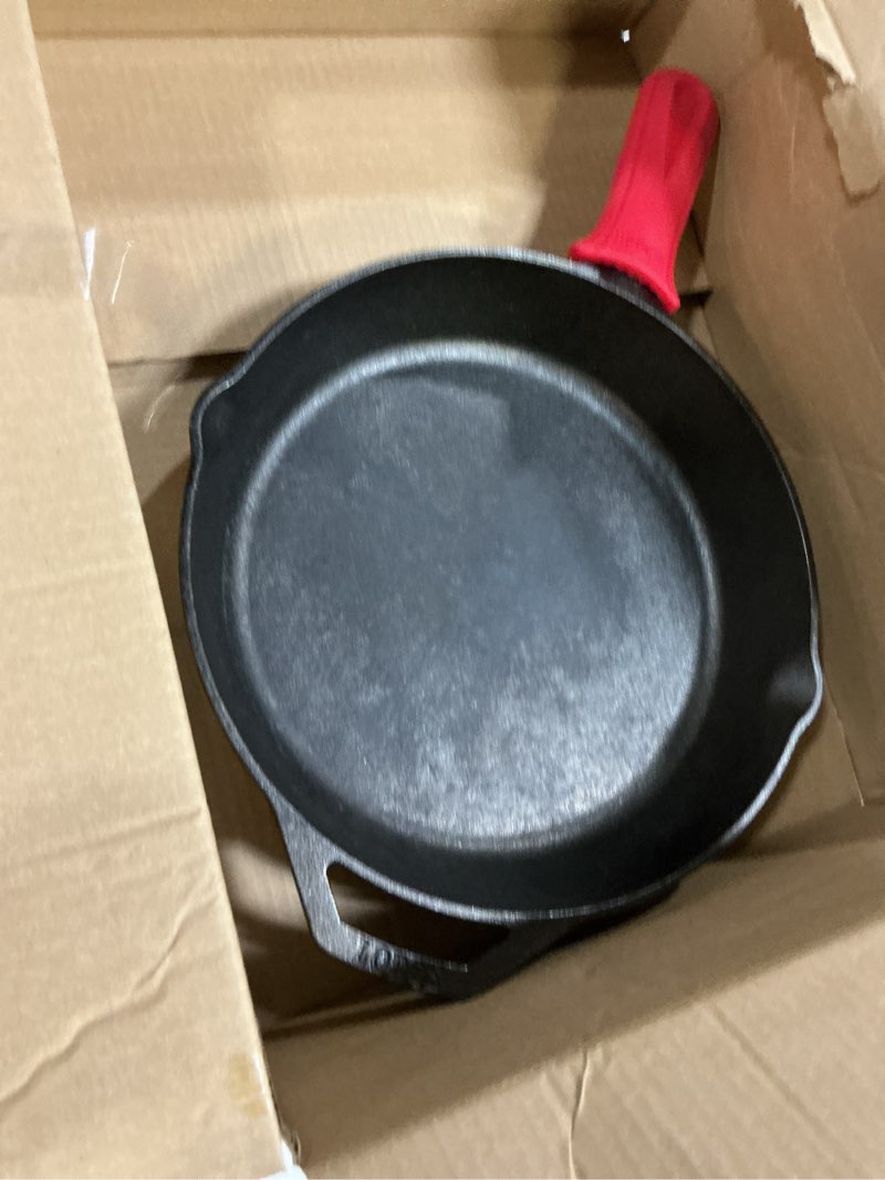 Condition photo showing Good Condition for Lodge Seasoned Cast Iron Skillet - Quality Frying Pan for the Stove, Oven, Grill & Campfire - Includes Silicone Hot Handle Holder - Non-Toxic, Nonstick & Long-Lasting - 12 Inches