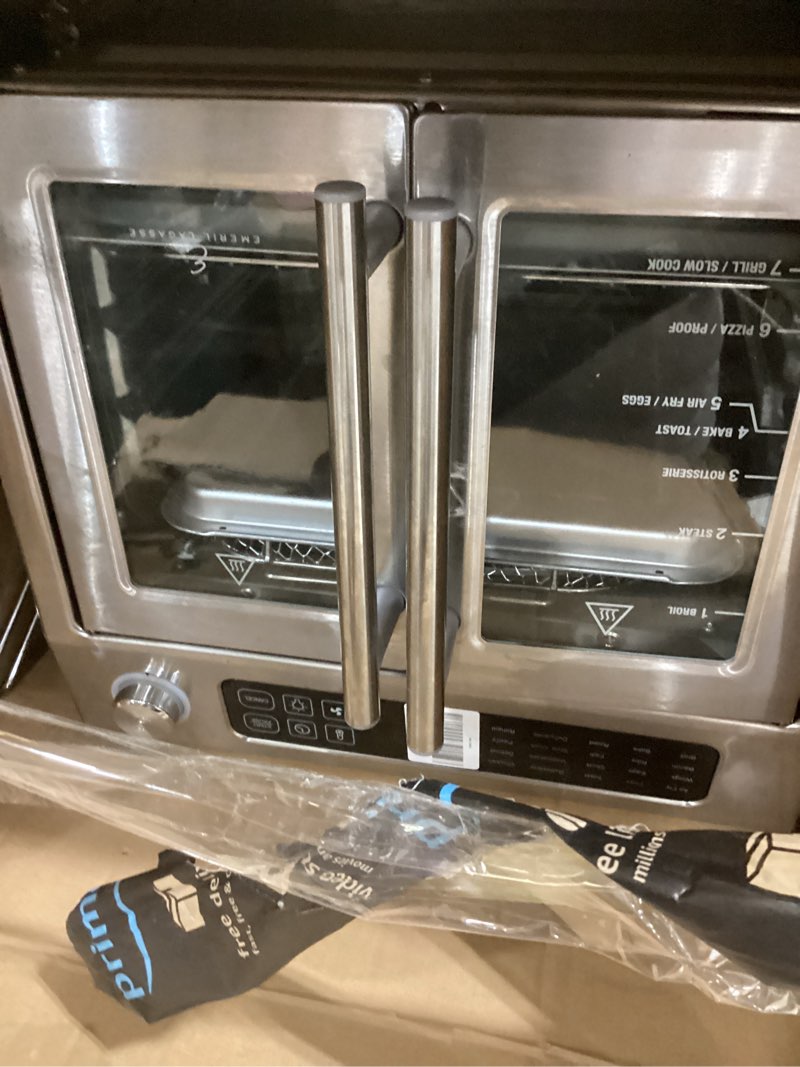 Condition photo showing New/Like New for dan - emeril lagasse extra large french door air fryer toaster oven combo, 24 cooking functions and digital controls, 7 accessories included, stainless steel finish, 26qt capacity