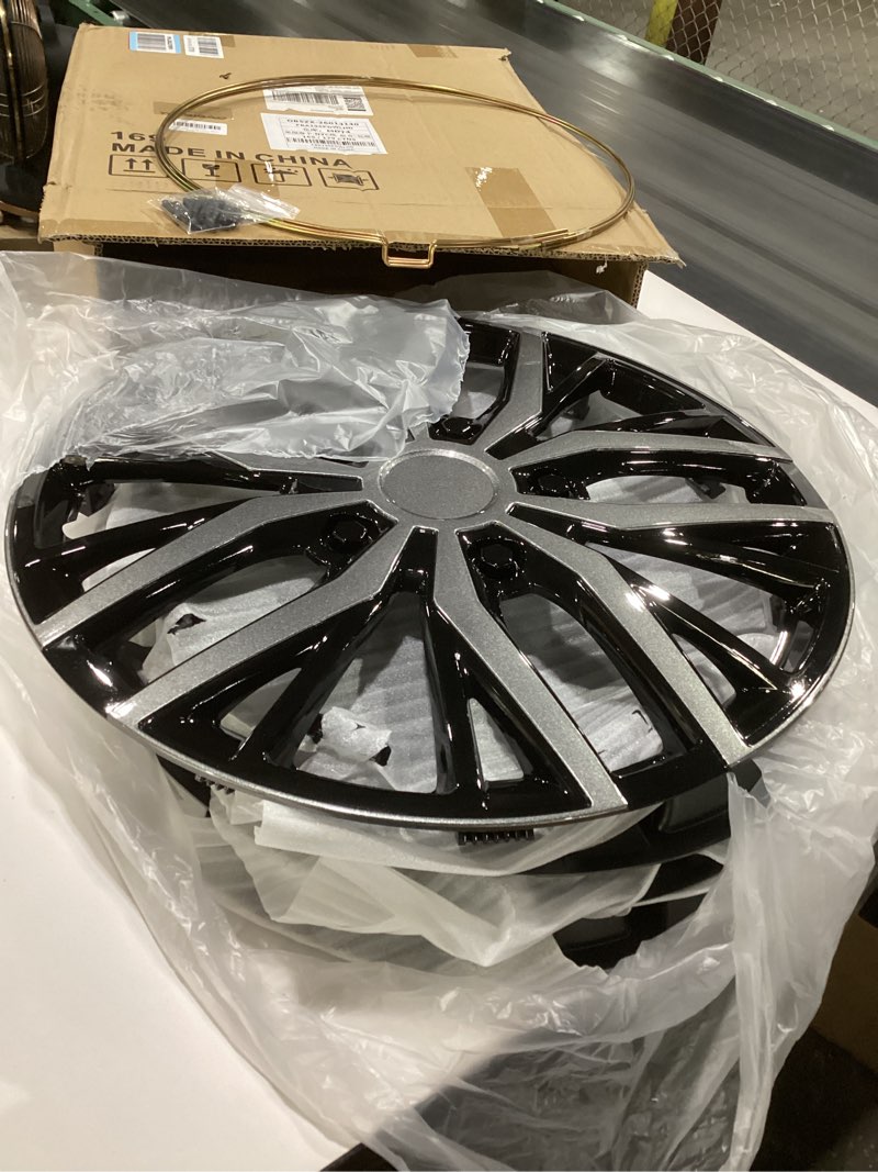 Condition photo showing As Is for 17 inch silver hubcaps with adjustable steel retention rings, premium abs universal fit, set of 4 wheel covers (black-gunmetal grey)