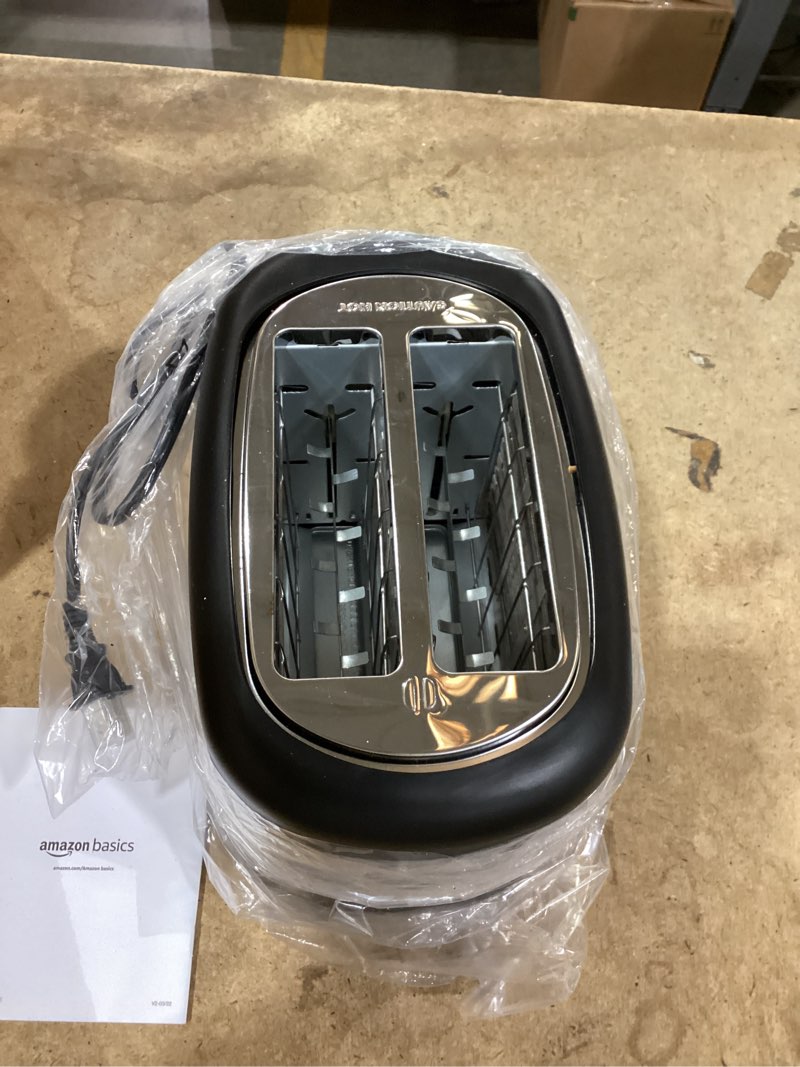Condition photo showing As Is for amazon basics 2 slice toaster, with 6 browning settings, extra wide slots for bagels and special breads, removable easy-to-clean crumb tray, cancel/defrost/bagel buttons, 900w, black & silver 2 slice silver front