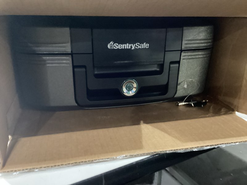 Condition photo showing Good Condition for SentrySafe Charcoal Gray Fireproof and Waterproof Safe Box with Key Lock, Portable Chest for Money, Passport, 0.28 Cubic Feet, 6.6 x 15.4 x 14.3 Inches, CHW20221 1/2 Hr. Fireproff, Lid Straps