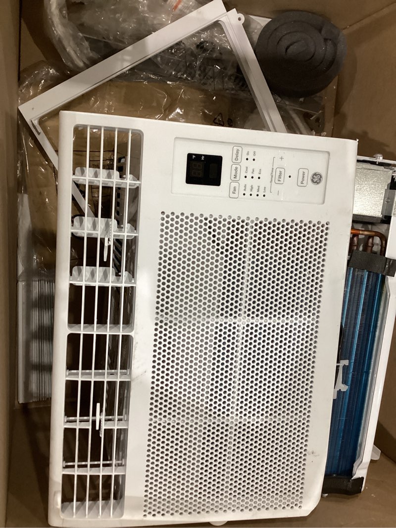 Condition photo showing As Is for  ge 6,000 btu electronic window air conditioner, cools rooms up to 250 sq ft, digital controls with remote, energy saver mode, 24hr timer, easy install kit included, white