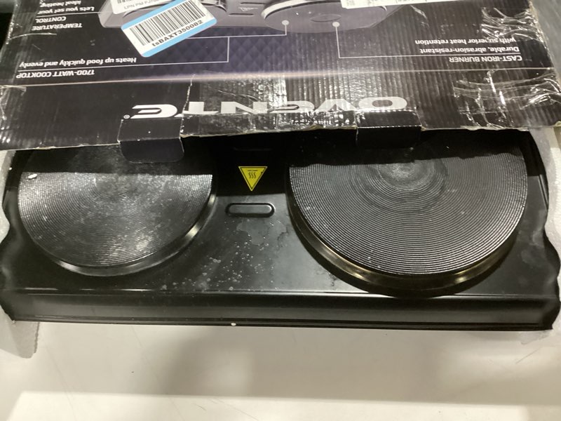 Condition photo showing As Is for ovente electric countertop double burner, 1700w cooktop with 7.25" and 6.10" cast iron hot plates, temperature control, portable cooking stove and easy to clean stainless steel base, black bgs102b bgs102b - black