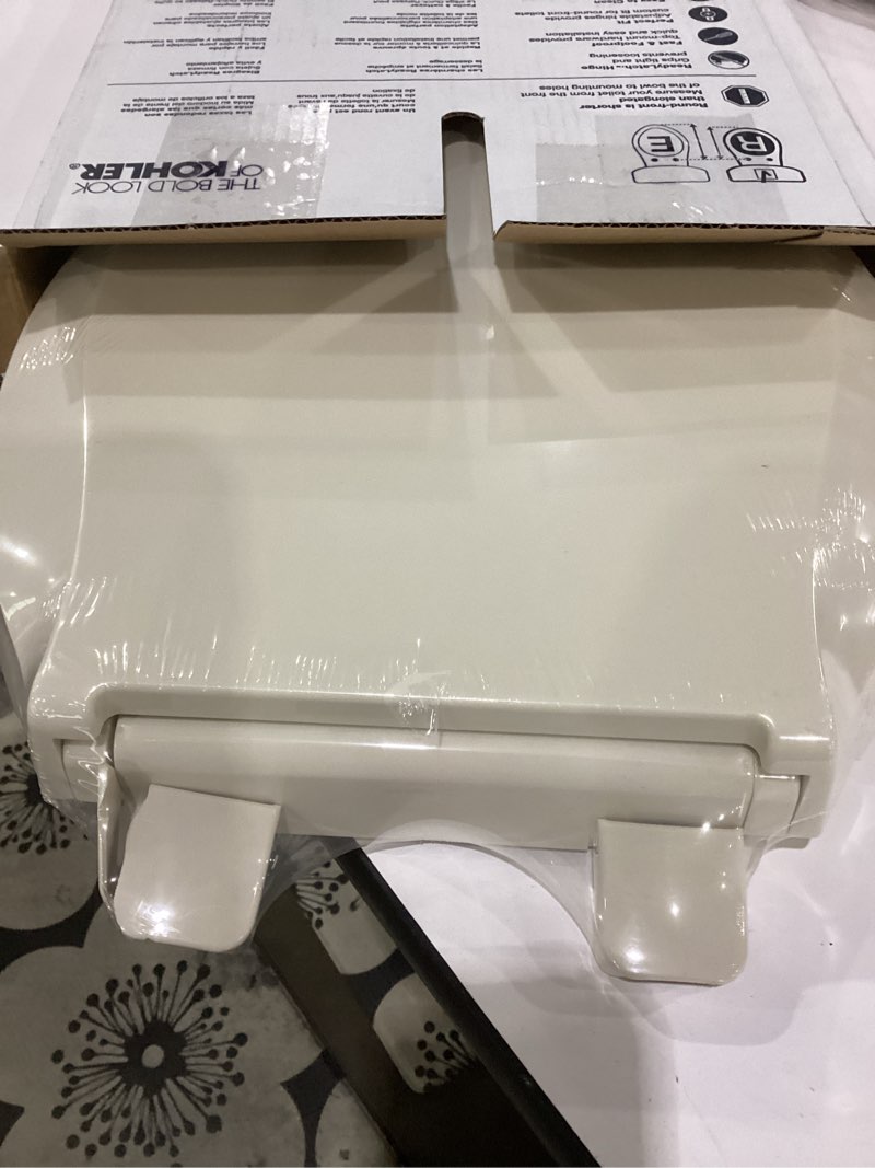 Condition photo showing New/Like New for kohler 4639-rl-47 cachet readylatch quiet-close round toilet seat, slow close lid and seat, grip-tight bumpers and installation hardware, almond