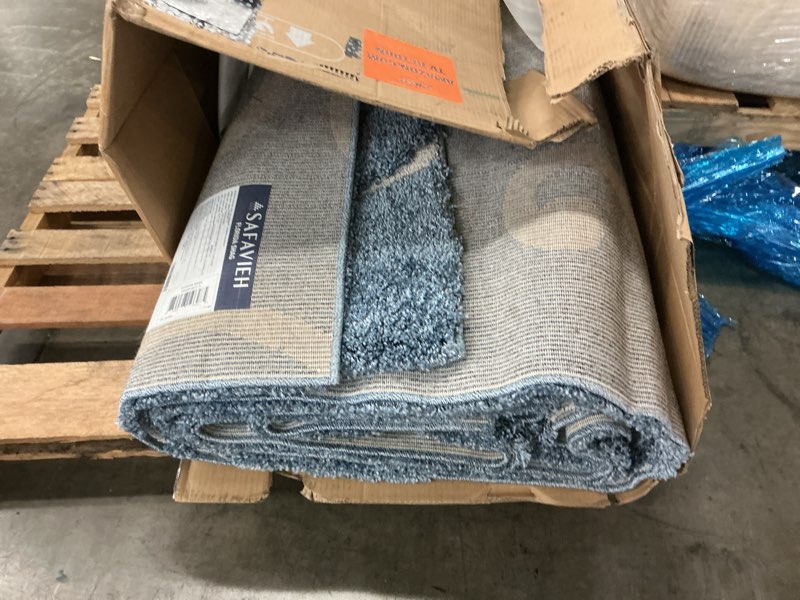 Condition photo showing As Is for safavieh area rug 9x12 - florida shag collection - large - light blue & cream, scroll design, non-shedding & easy to clean, high-low plush pile, ideal for living room, bedroom, dining (sg455-6011) 9' x 12' (rectangular) light blue/cream