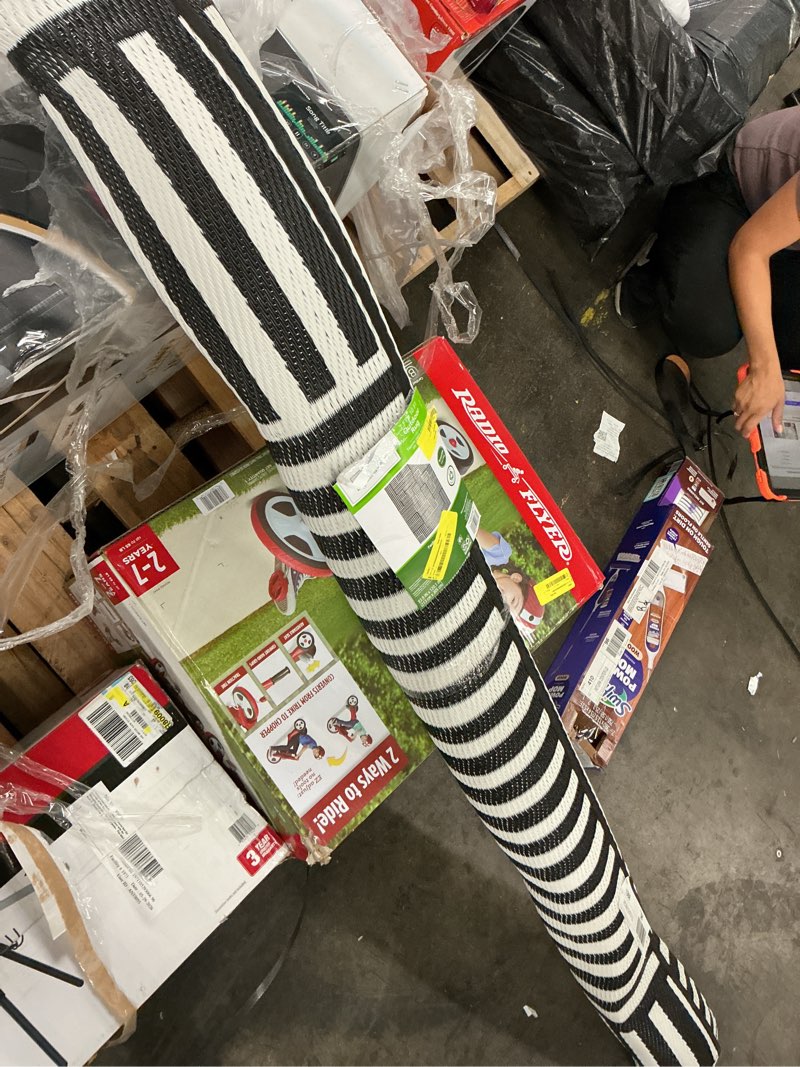 Condition photo showing As Is for mainstays new block black and white stripe plastic outdoor rug, 7'x10'