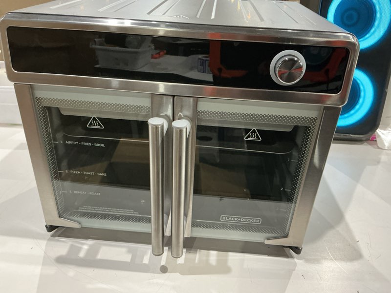 Condition photo showing Good Condition for black+decker crisp 'n bake air fryer toaster oven combo, 12 in 1 countertop convection oven cooks food fast, fits a whole pizza or 6 toast slices, french doors with stainless steel finish