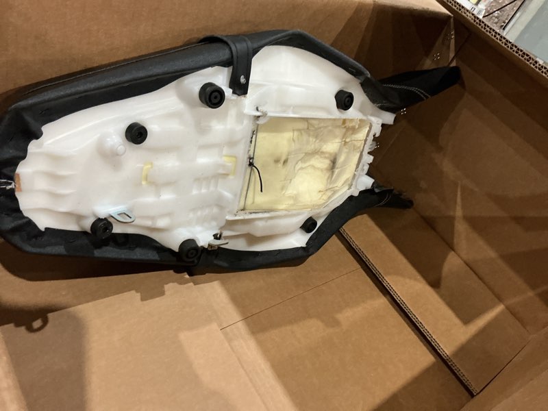 Condition photo showing As Is for seat cover in black staple on marine skin