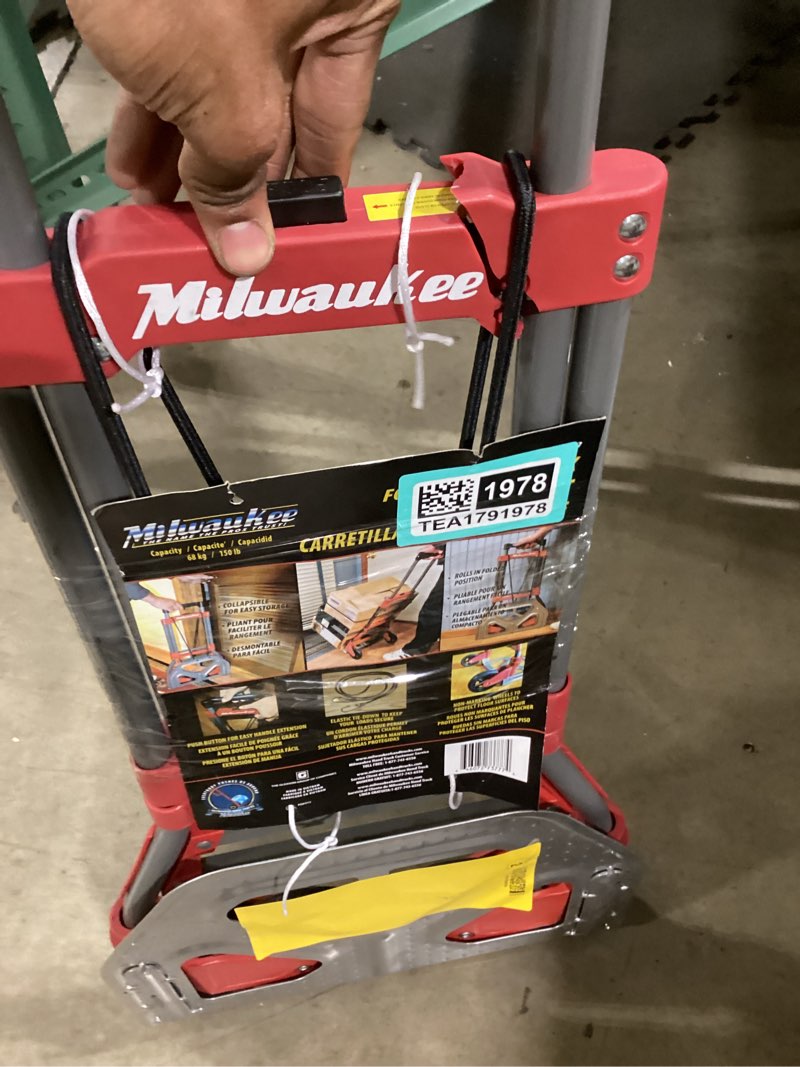 Condition photo showing As Is for Milwaukee 150-lb Capacity 2 -Wheel Red Steel Folding hand truck has cracks 