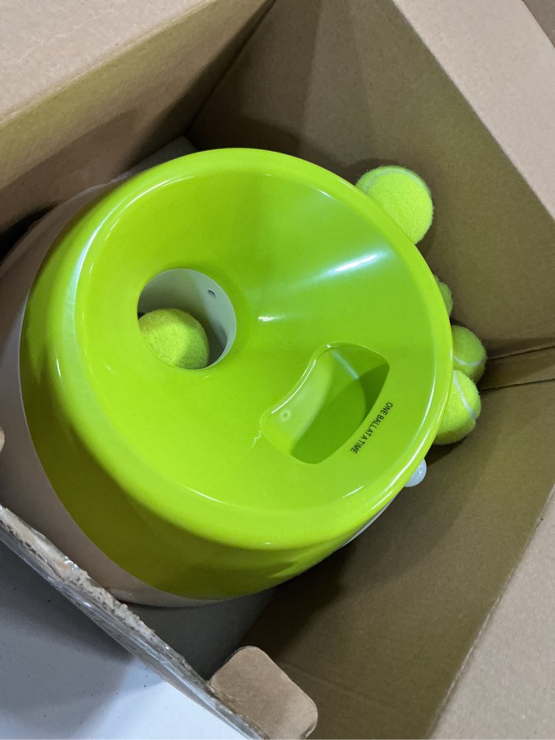 Condition photo showing As Is for elevon automatic dog ball launcher, indoor/outdoor interactive dog toy with three ranges, includes 6 mini tennis balls and a data line, suitable for small and medium-sized dogs, green olive medium machine, 6 balls