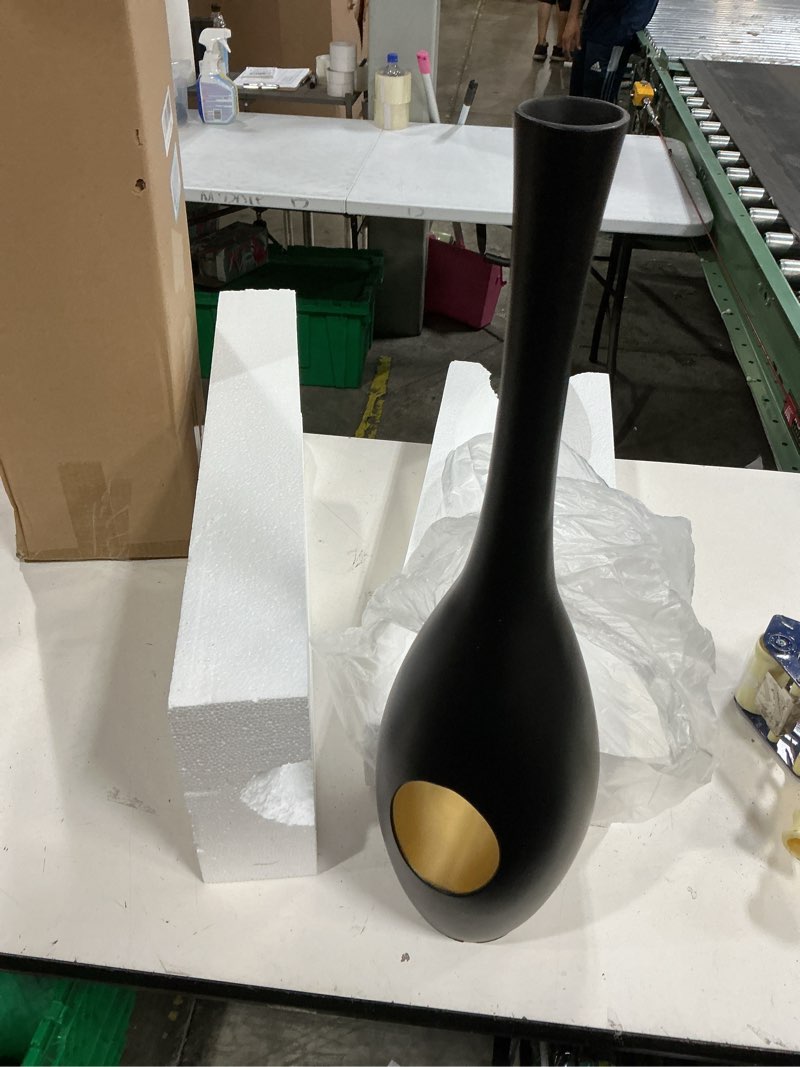 Condition photo showing New/Like New for black and gold floor vase features a sleek, tall design with a hollow cutout