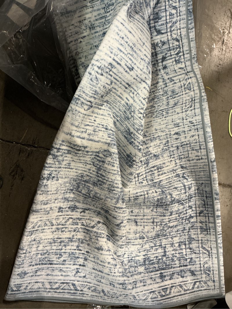 Condition photo showing As Is for (Similar to stock photo) Amelia 9 ft. x 12 ft. Ivory/Blue Abstract Distressed Area Rug