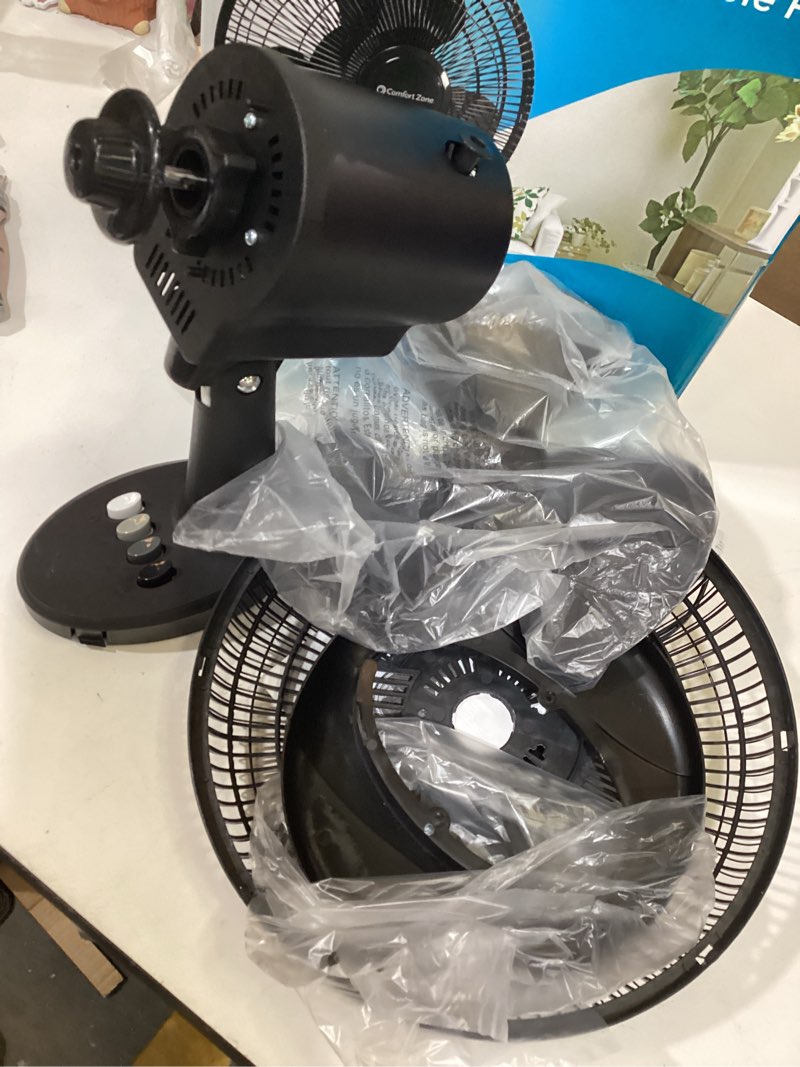 Condition photo showing As Is for comfort zone oscillating table fan with adjustable tilt, convenient push button controls, quiet, 12 inch, 3 speed, desk fan, airflow 7.25 ft/sec, ideal for home, bedroom, dorm & office, cz121bk
