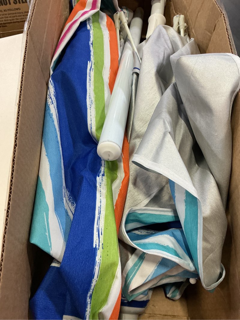Condition photo showing As Is for multi-color striped beach umbrella