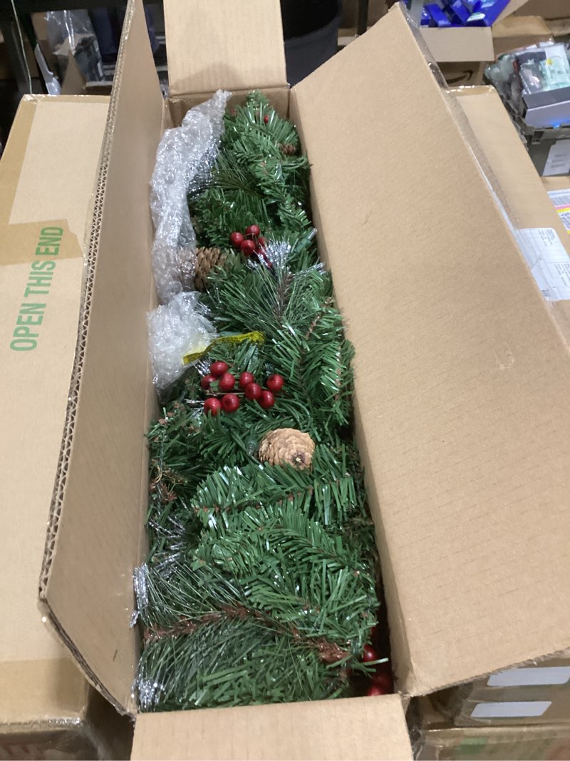 Condition photo showing New/Like New for national tree company 9 ft pre-lit crestwood spruce artificial christmas garland, christmas decoration with glitter, pinecones, red berries, 50 clear lights, 180 tips, green plug in tree