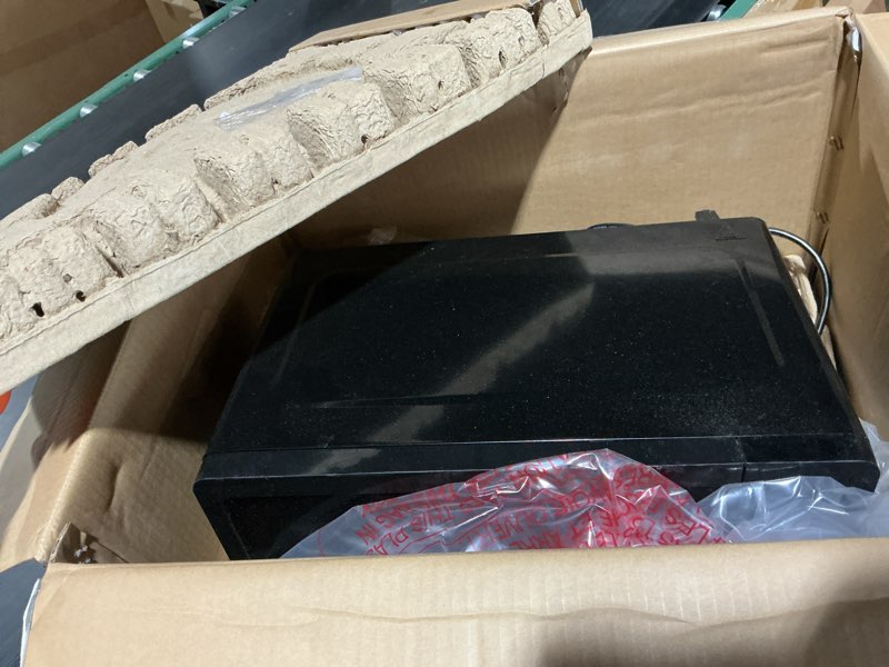 Condition photo showing As Is for mainstays 0.7 cu ft compact countertop microwave oven, black
