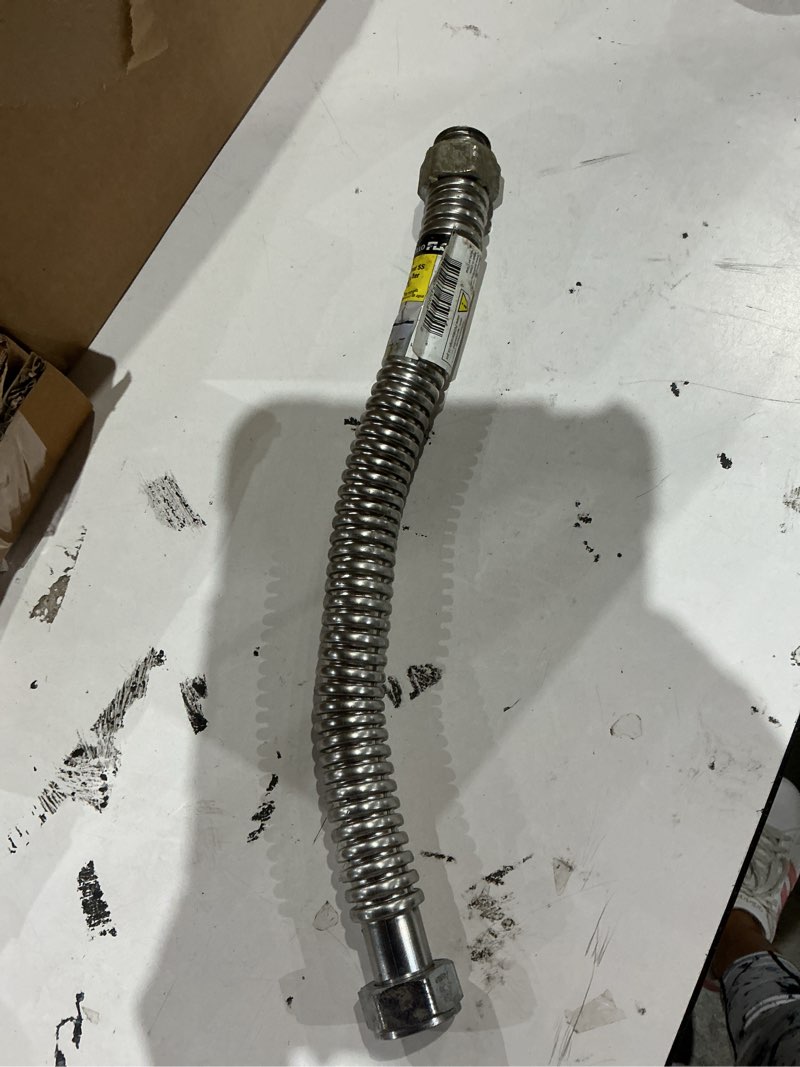 Condition photo showing As Is for apollo 18-in 1-in-in fip inlet x 1-in-in fip outlet stainless steel water heater connector