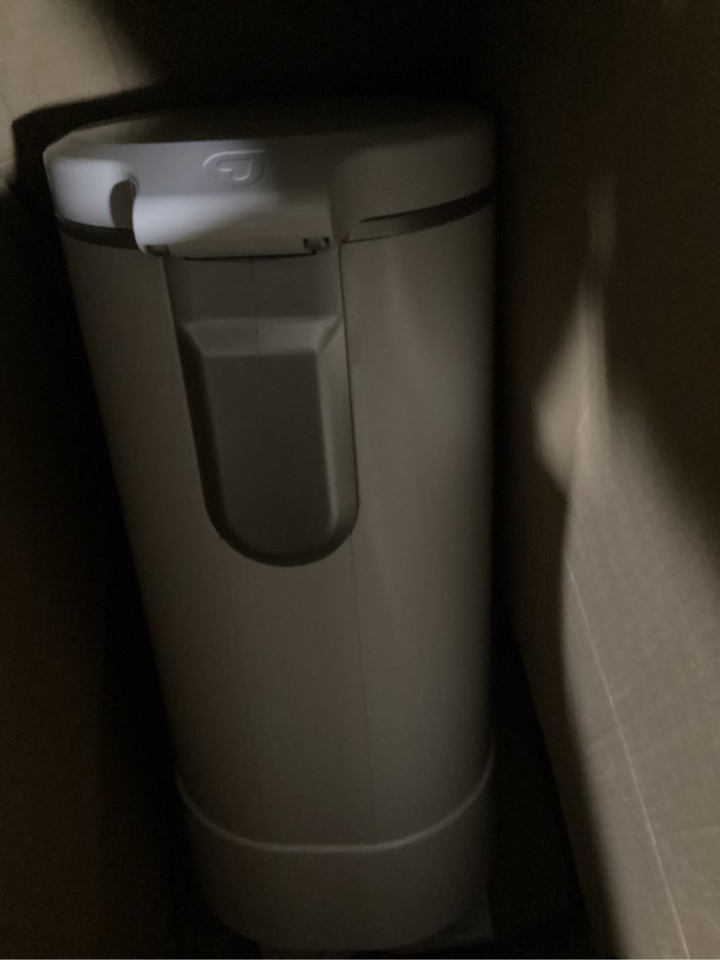 Condition photo showing As Is for munchkin® step™ diaper pail powered by arm & hammer, #1 in odor control, award-winning, includes 1 snap, seal & toss™ bag, 1 starter refill ring, and 1 puck™ baking soda cartridge