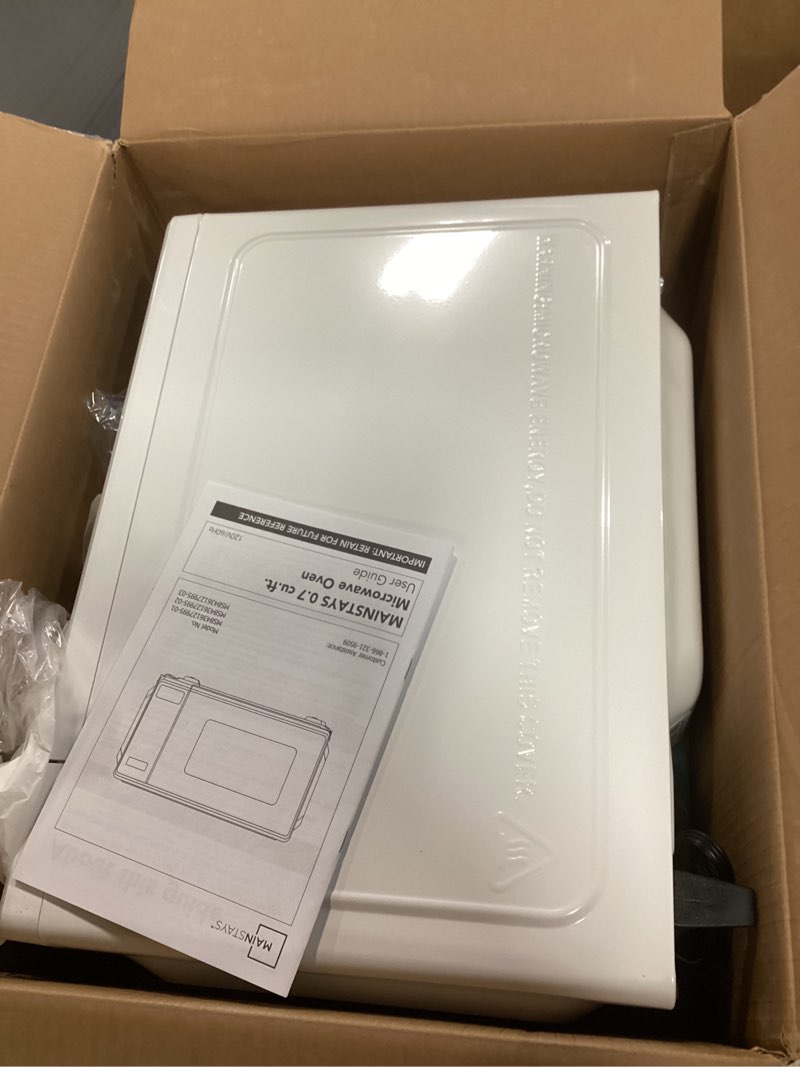 Condition photo showing As Is for mainstays 0.7 cubic foot microwave 700 watts, white