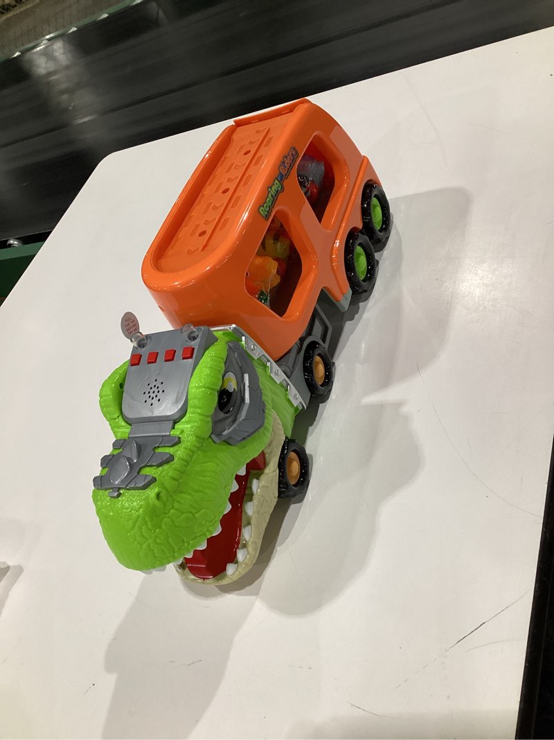 Condition photo showing New/Like New for JOYIN Dinosaur Toys for Kids 2-4, Toddler Boy Toys, Dinosaur Carrier Truck with 6 Rubber Car Vehicles, Christmas Birthday Gifts with Music & Lights for 2 3 4 5 Year Old Tropical Dinosaur Truck