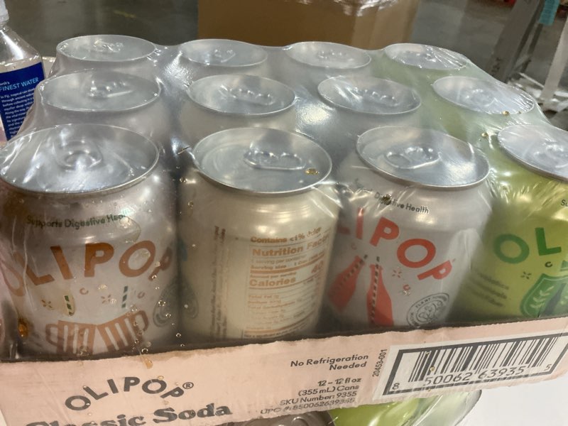 Condition photo showing As Is for (Best by 03/17/27) OLIPOP Prebiotic Soda Pop, Classic Soda Variety, Pantry Pack Packed with Prebiotics, Fiber, and Botanicals, Gluten Free, Vegan, GMO Free, 12oz (12-Cans)