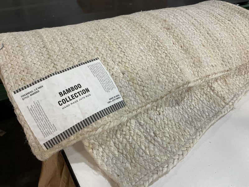 Condition photo showing As Is for FRELISH DECOR Handwoven Jute Area Rug - 6x9 Feet Natural Yarn - Rustic Vintage Beige Braided Reversible Rectangular Rugs for Bedroom - Kitchen - Living Room - Farmhouse (6' x 9') Natural 6' x 9' (Rectangular)