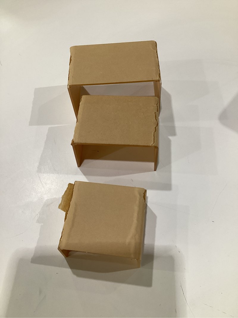 Condition photo showing As Is for Super Z Outlet Clear Acrylic Riser Jewelry Showcase Display Set of Three (3-Inch, 4-Inch, 5-Inch) (1 Set)