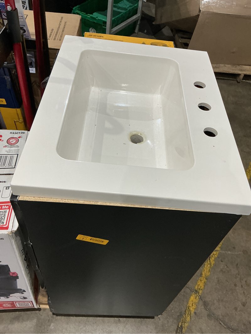 Condition photo showing As Is for bought last week style selections cauley  black single sink bathroom vanity with white cultured marble