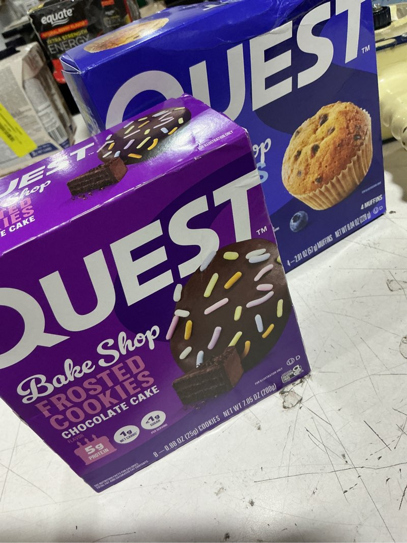 Condition photo showing As Is for (exp: 07/29/2026) quest bake shop goodies!!! 4 pack blueberry muffins & 8 pack of chocolat cake frosted cookies