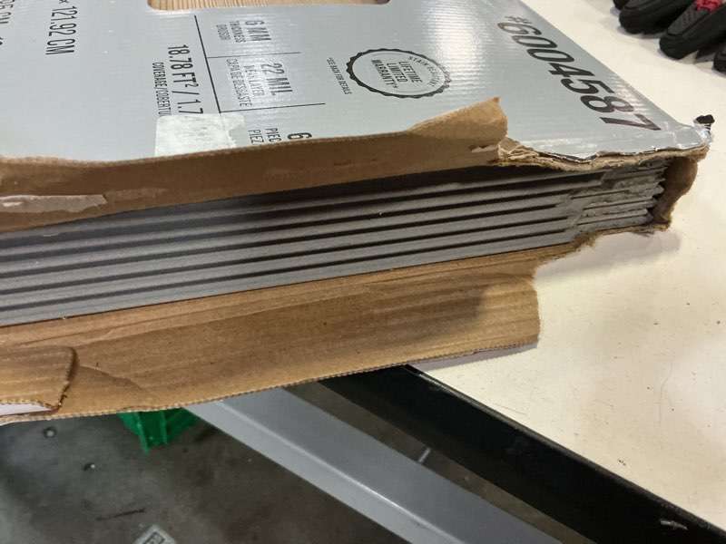 Condition photo showing As Is for stainmaster elkton pine brown 22-mil x 9-in w x 47-in l waterproof interlocking luxury vinyl plank flooring (18.78-sq ft/ carton)