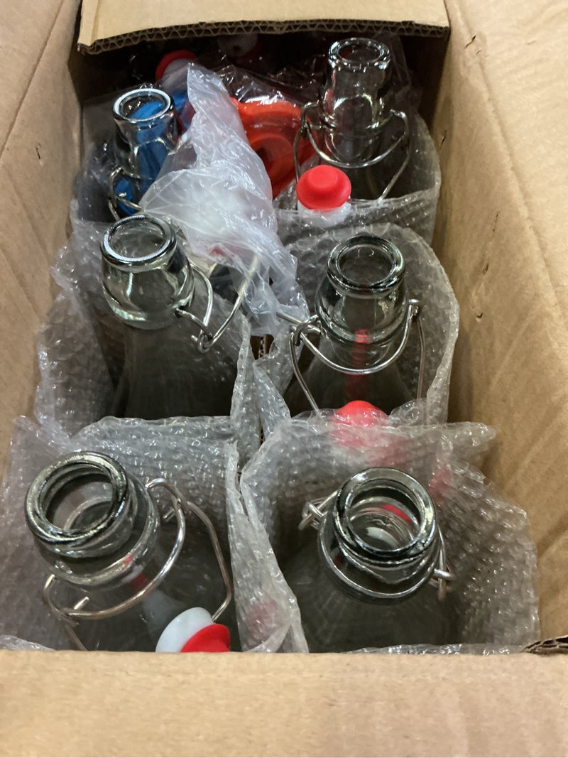 Condition photo showing New/Like New for 8 pack [1 l / 33 fl. oz.] swing top glass bottles w/ airtight stopper lids – flip top brewing bottle for fermentation, kombucha, mead, vinegar, beer, kefir, wine, soda – with 8 extra seals & 2 pourer