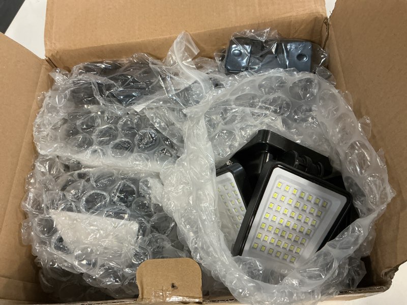 Condition photo showing Good Condition for lywalt solar lights outdoor - 3000lm 188 led motion sensor outdoor lights, 4 heads ip65 waterproof powered security flood lights, 270°wide lighting angle wall light with sensors for backyard (4 pack)