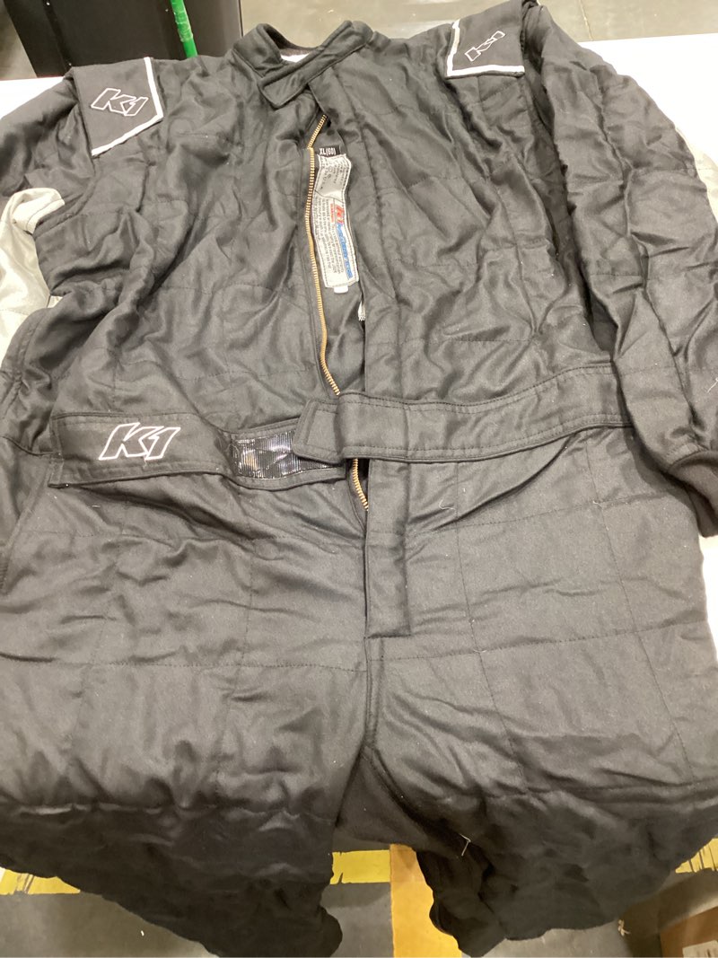 Condition photo showing As Is for k1 racegear 20-otl-ng-xl driving suit, outlaw, 1-piece, sfi 3.2a/5, double layer, nomex, black/gray, x-large, each ( driving suit only)