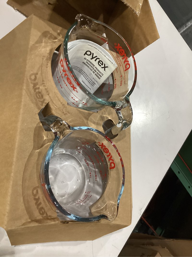 Condition photo showing New/Like New for pyrex 2 piece glass measuring cup set  includes 1-cup  and 2-cup tempered glass liquid measuring cups  dishwasher  freezer  microwave  and preheated oven safe  essential kitchen tools