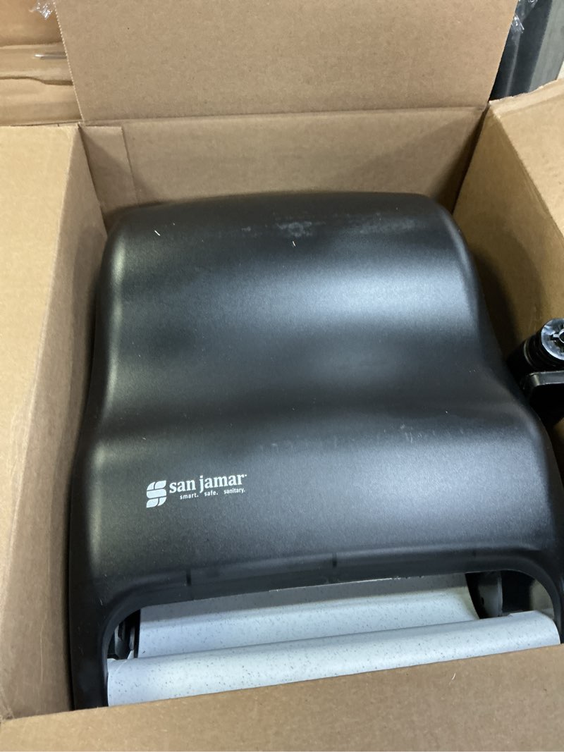 Condition photo showing As Is for san jamar classic paper towel dispenser with lever for bathroom, kitchens, restaurants, and cafeterias, plastic, for universal 800' 8" rolls, black pearl