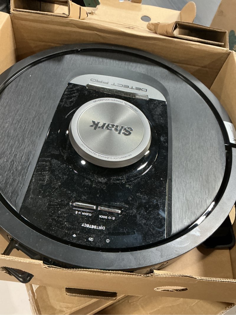 Condition photo showing As Is for Shark PowerDetect Self-Empty Robot Vacuum with NeverStuck Technology, Auto Deep-Clean Carpets & Hardfloors, 30 Day Capacity HEPA Bagless Base, for Pet Hair, WiFi Black, AV2820S PowerDetect (30 Days)