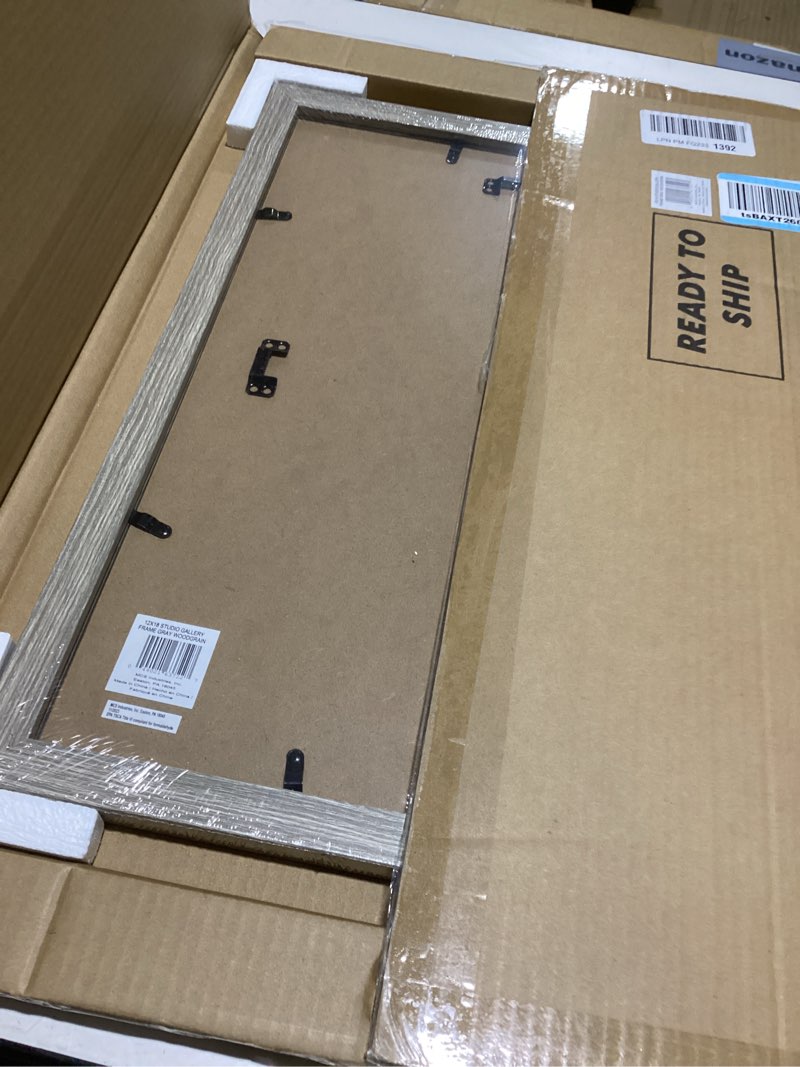 Condition photo showing New/Like New for mcs studio gallery 12x18 picture frame gray woodgrain engineered wood, rectangle photo frame for photos, posters & art prints (1-pack) 1-pack 12x18 gray woodgrain