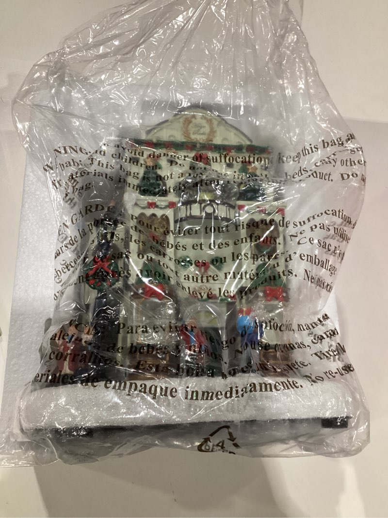 Condition photo showing As Is for MOMENTS IN TIME Fine Jewelry Shop11”H Lighted Christmas Village Building with LED Lights & Christmas Music Hand-Painted Polyresin Holiday Décor Power Adapter Included Gift Ready Display Piece