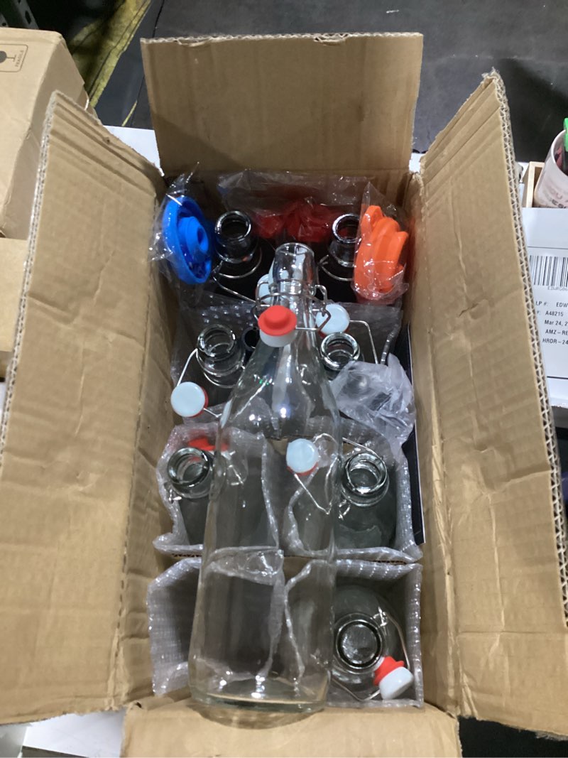 Condition photo showing New/Like New for 8 pack [1 l / 33 fl. oz.] swing top glass bottles w/ airtight stopper lids – flip top brewing bottle for fermentation, kombucha, mead, vinegar, beer, kefir, wine, soda – with 8 extra seals & 2 pourer